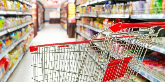 Empty shopping trolley in a supermarket aisle