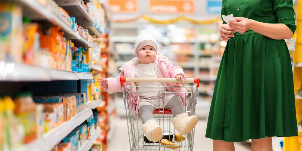 Baby sitting in shopping tolley
